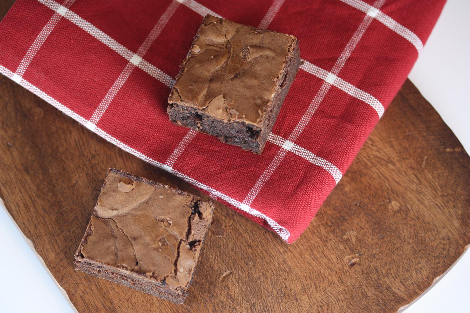 Fudgy Gluten Free brownies on red napkin