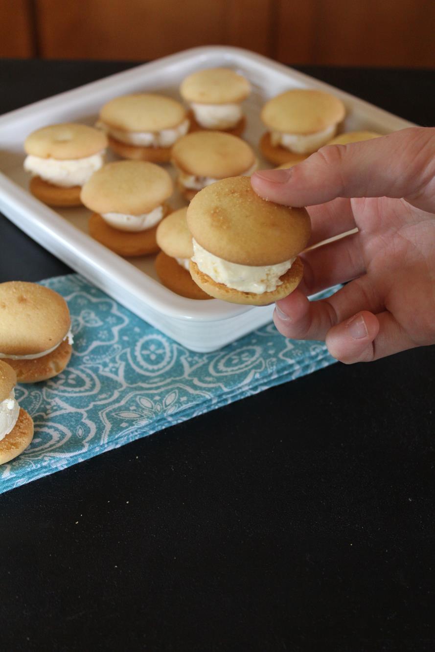 hand holing a vanilla wafer ice cream sandwich