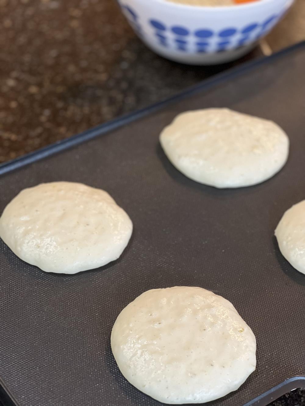 pancakes cooking on griddle