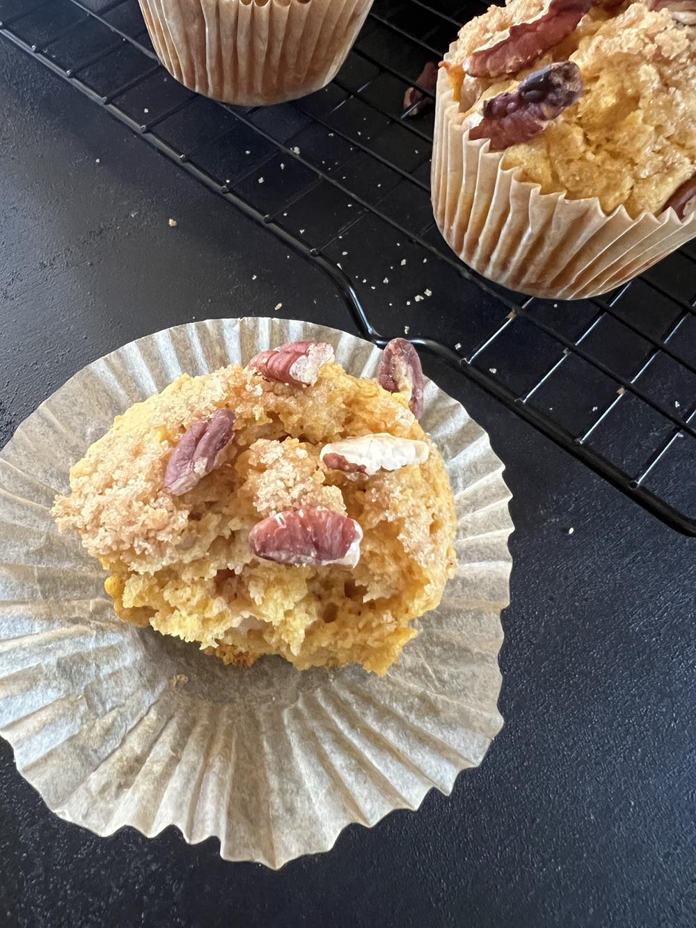 pumpkin muffins with pecans on black background