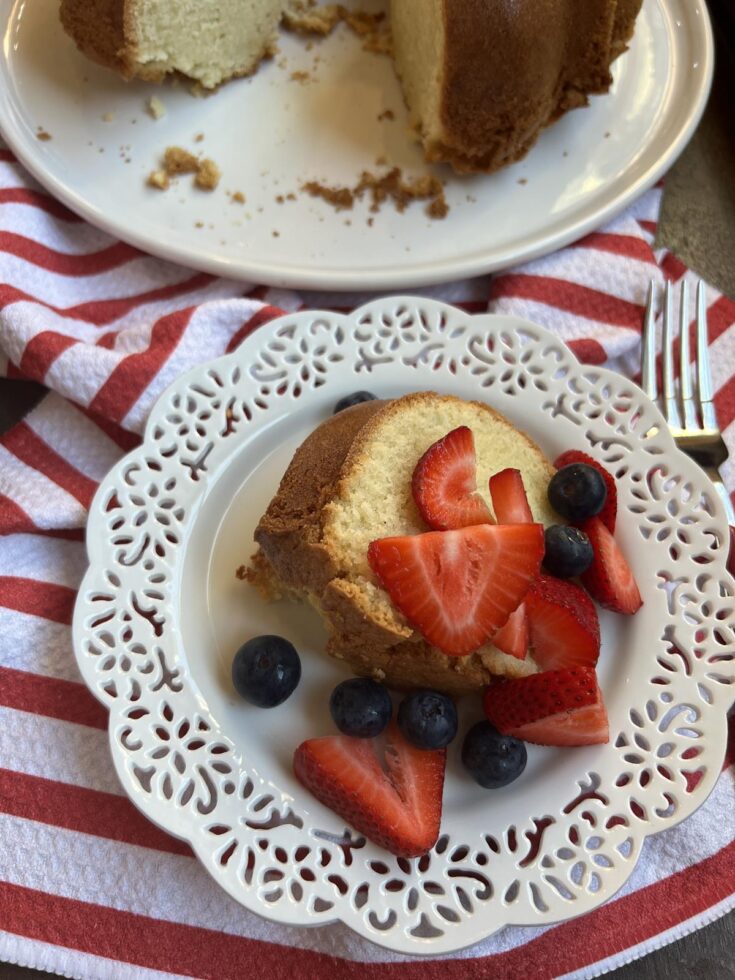 pound cake on whit plate with berries