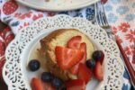 piece of pound cake with berries on white plate