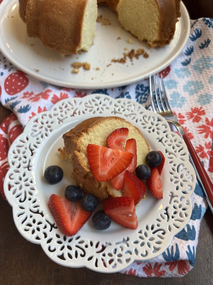 piece of pound cake with berries on white plate