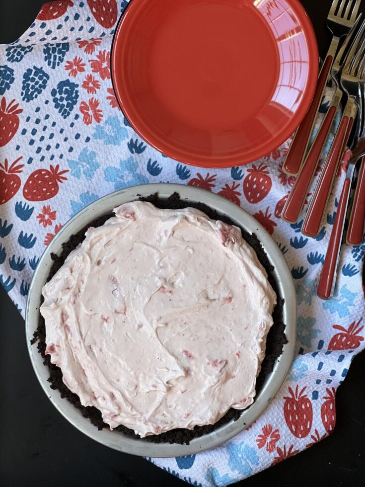 no bake strawberry pies on red white and blue napkin with stack of red and blue plates in the background