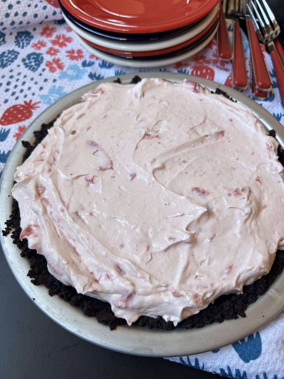 No Bake Berry Pie with Chocolate Crust in pie plate on red white and blue cloth with red white and blue plates in background