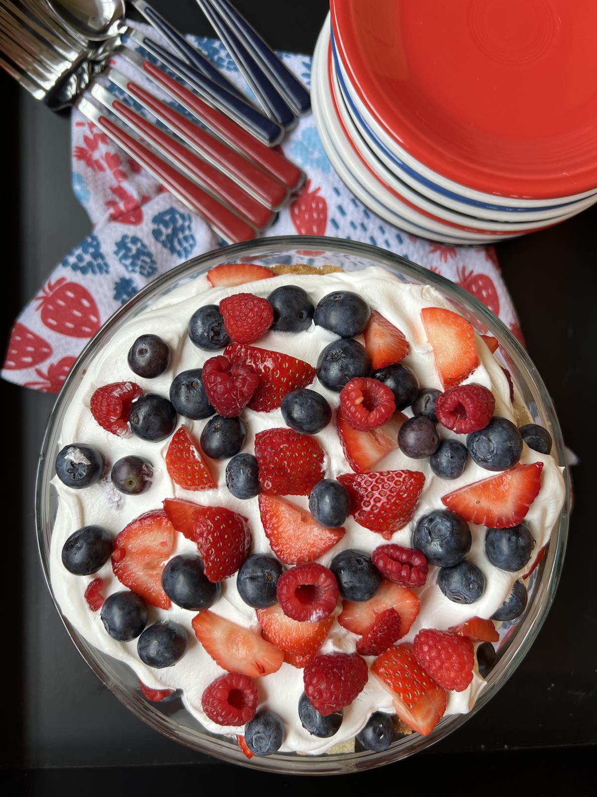 berries and pound cake in glass bowl with red white and blue plates