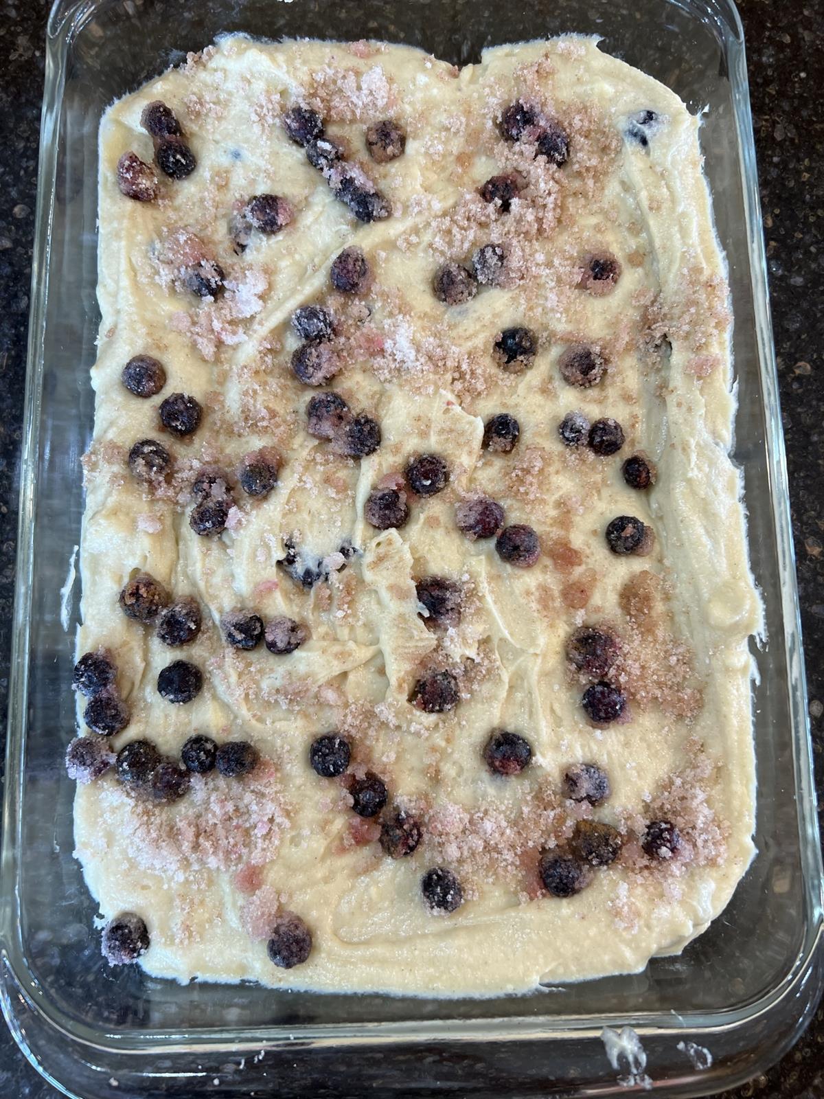 blueberry coffee cake batter in glass pan