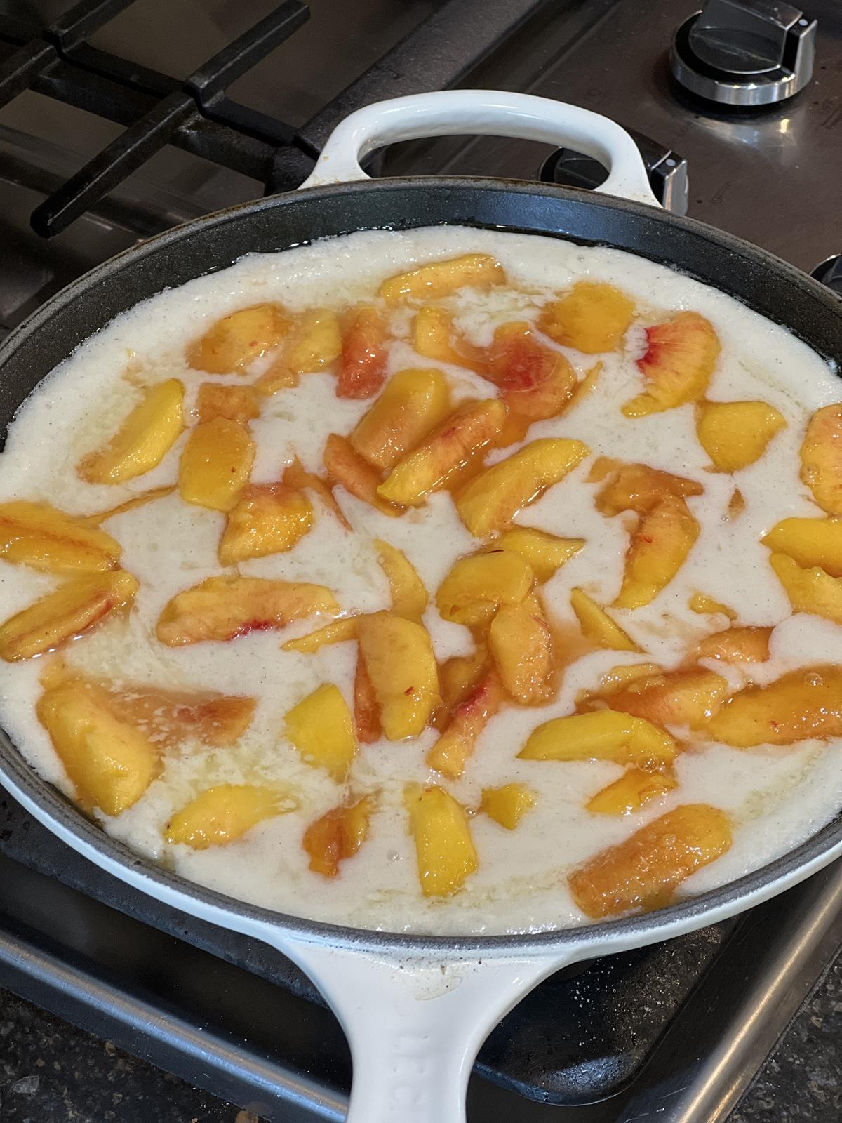 unbaked peach buckle in pan on stove top