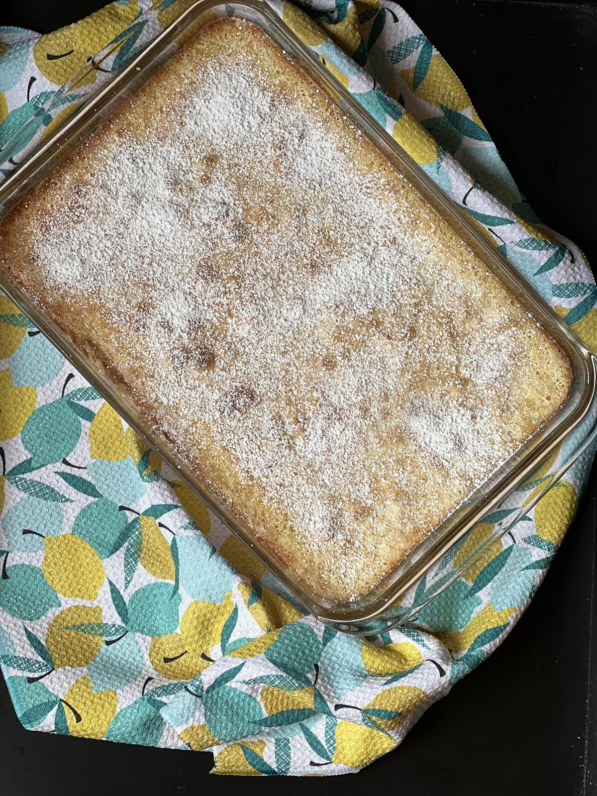 Pan of lemon bars on napkin printed with lemons on it.