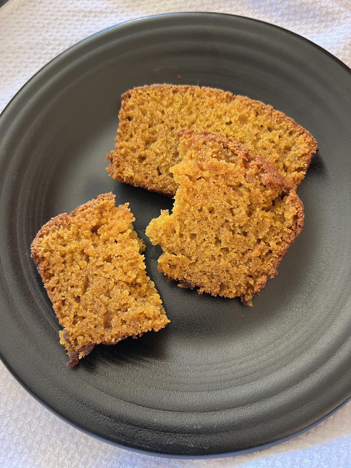 slices of pumpkin bread on black plate