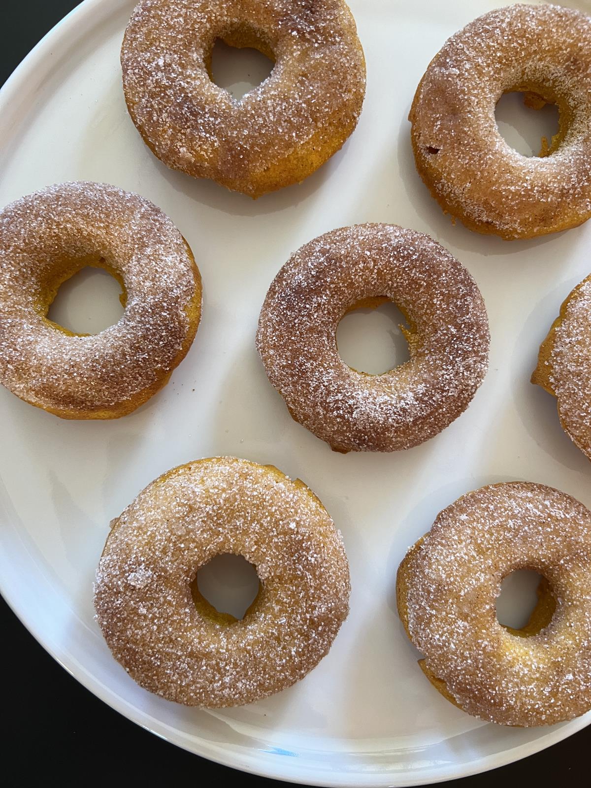 Gluten Free Pumpkin Doughnuts with cinnamon and sugar on white plate