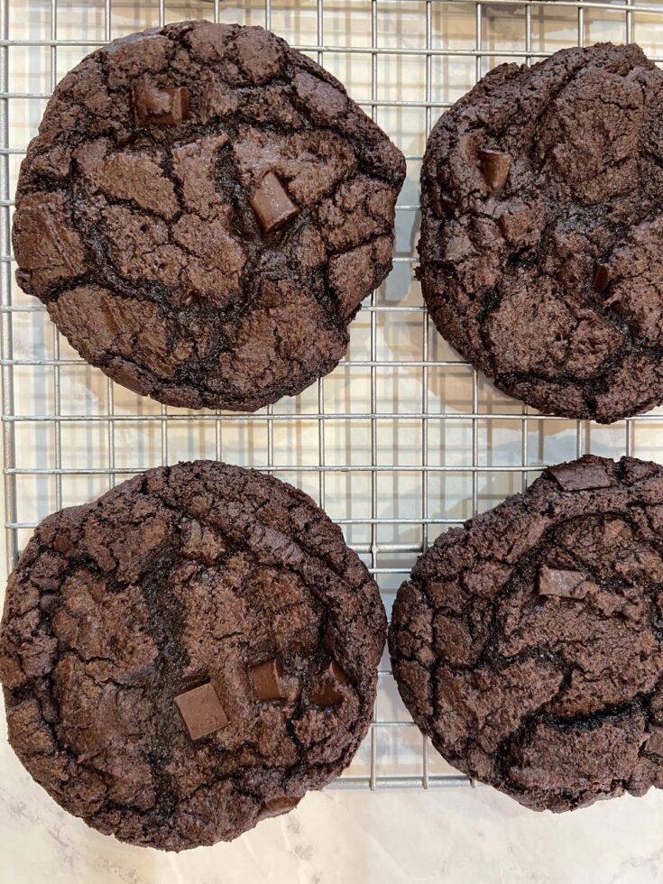 four double chocolate cookies on cooling rack