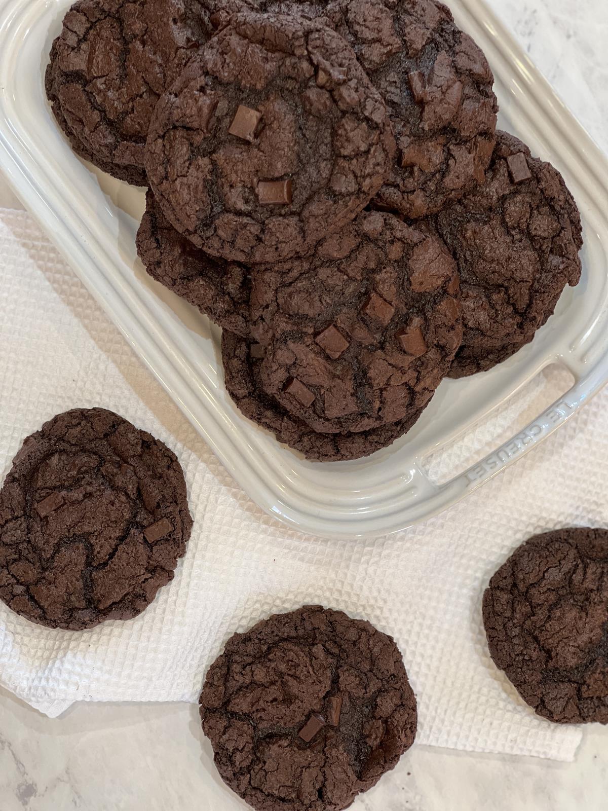 double chocolate cookies on white platter on white napkin