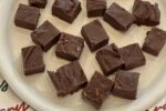 marshmallow fudge on white plate with Christmas napkin in background