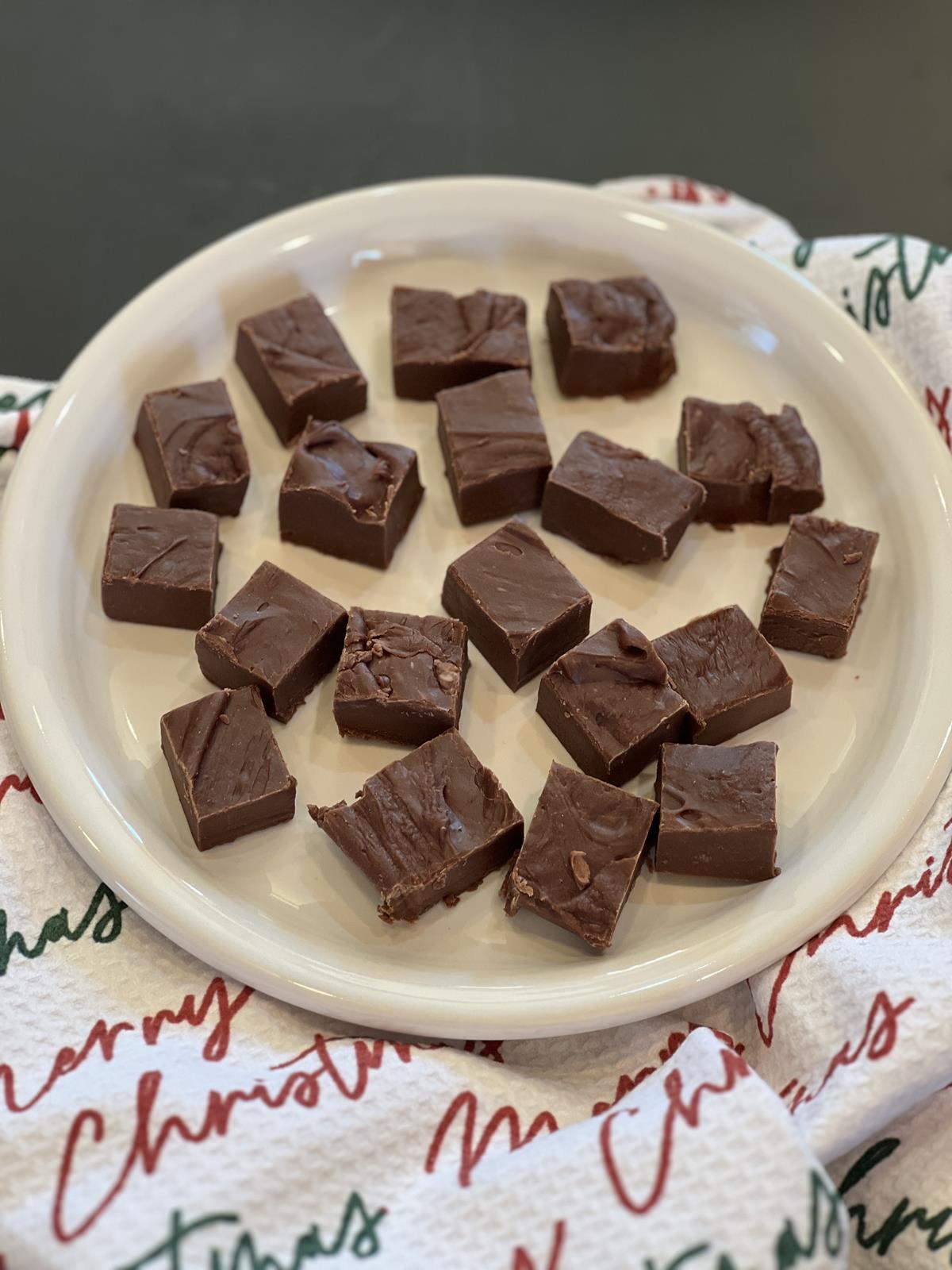 fudge on white plate with Christmas napkin in background