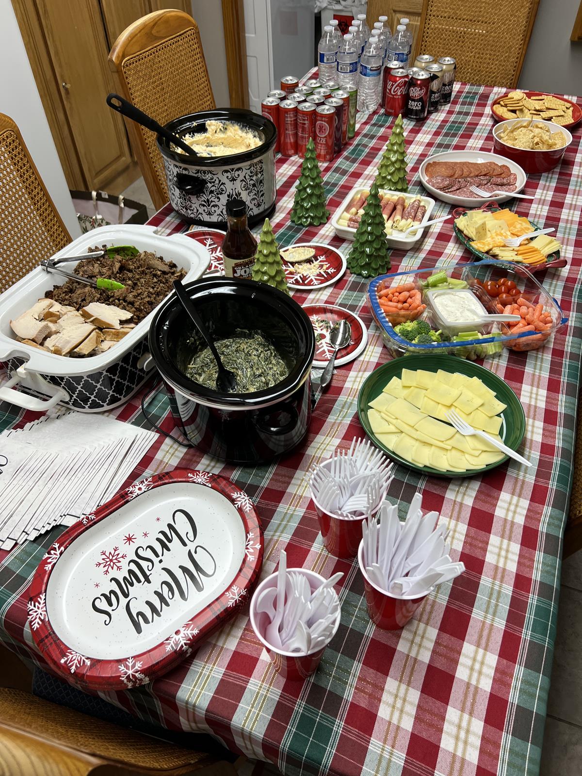 meats, cheese, drinks, dips, on red, white, and green table cloth