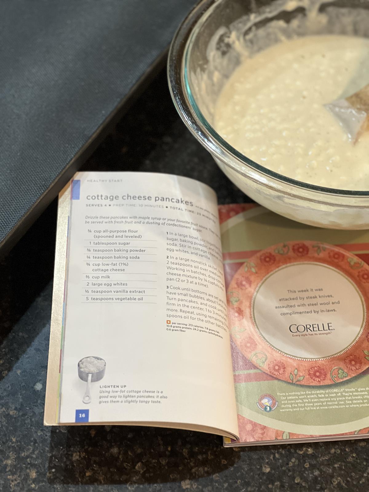 magazine next to a griddle and bowl of pancake batter