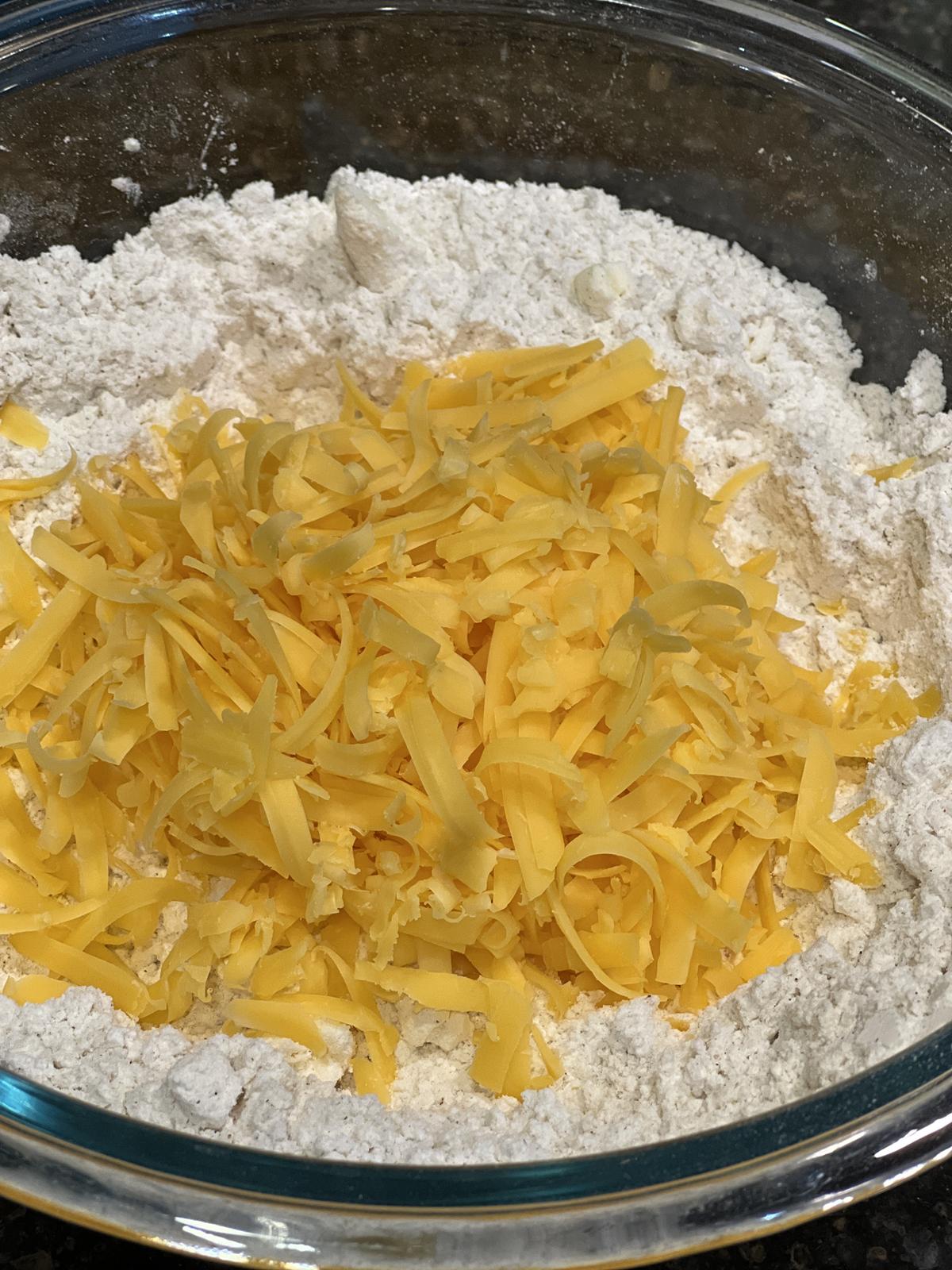 flour and cheddar cheese in glass bowl