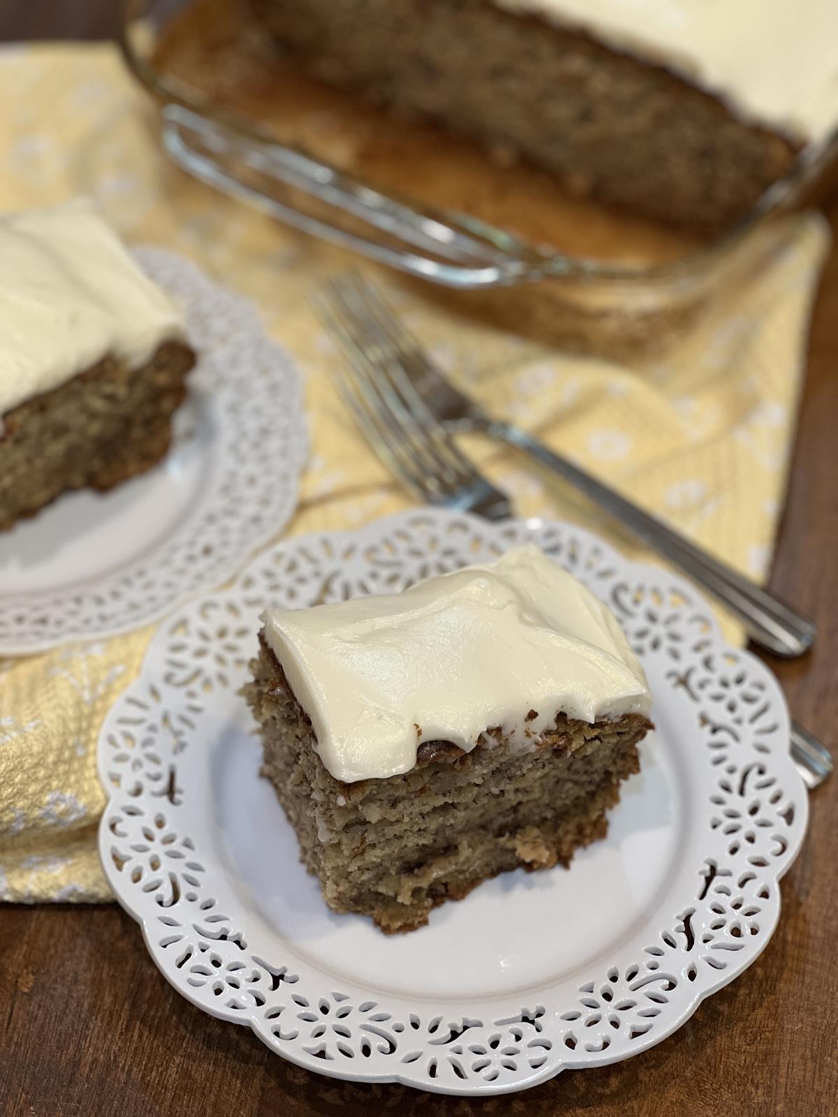 Ina Garten Banana Cake with frosting on white plate