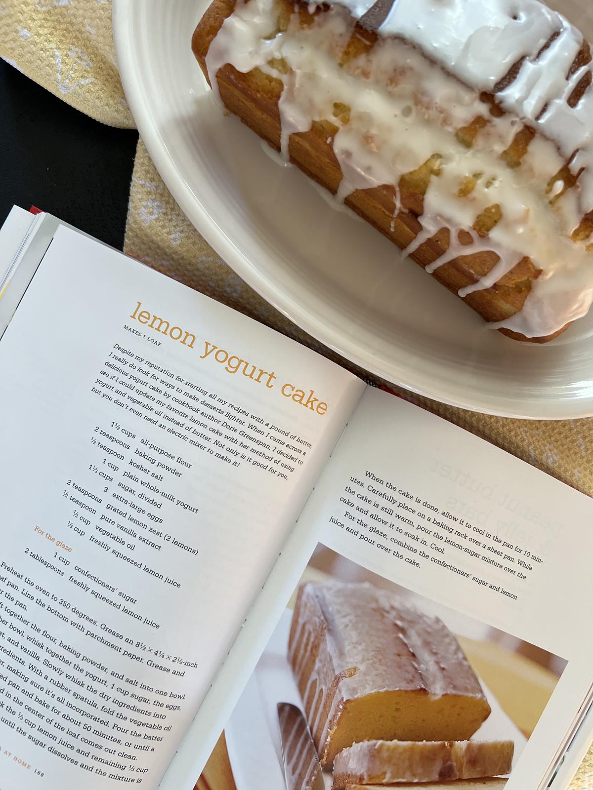 cookbook recipe for lemon yogurt cake and lemon cake on white platter