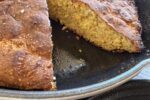 Martha Stewart Cheddar Cornbread Recipe in cast iron skillet on white cloth